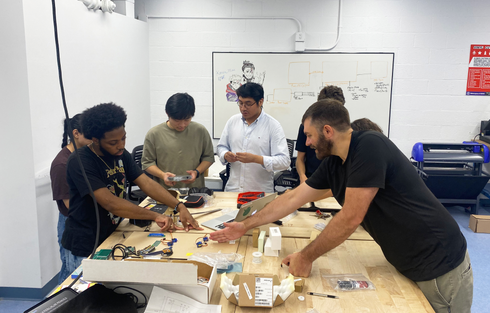 Professor and students working on STEM project